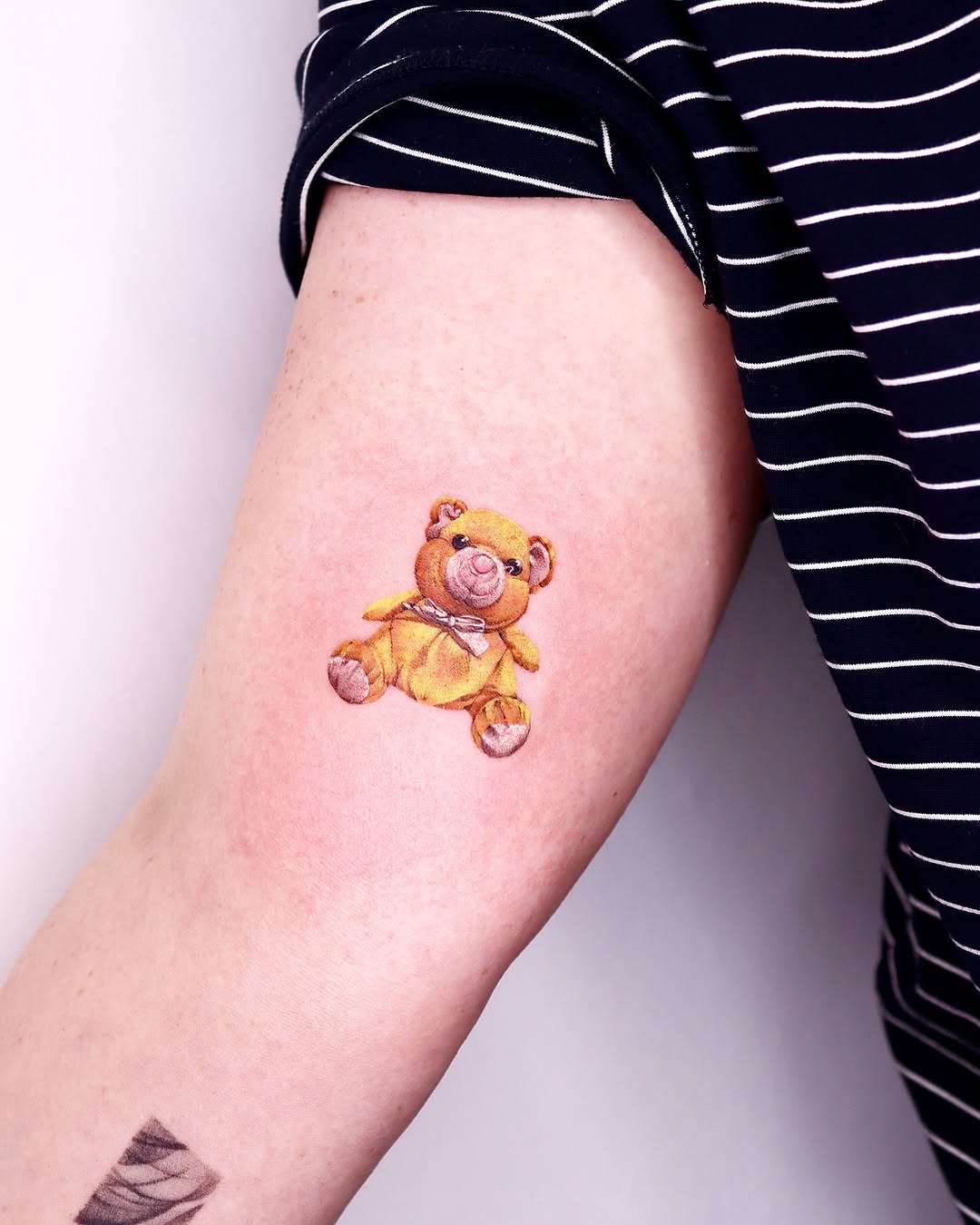 Adorable teddy bear tattoo with a soft vibe