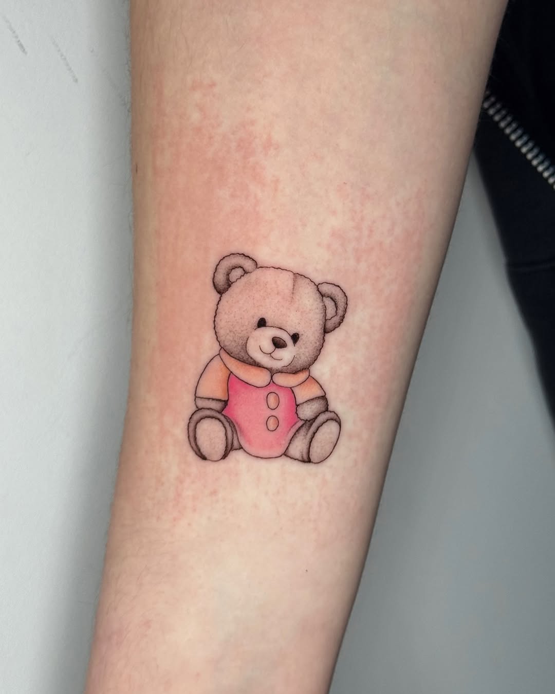 Whimsical teddy bear tattoo with playful vibes