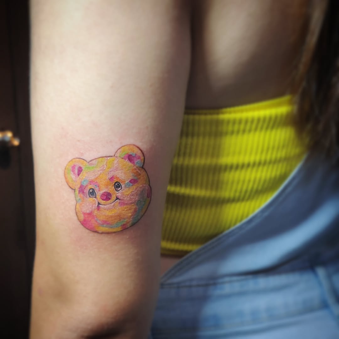 Vibrant bear tattoo with a playful twist