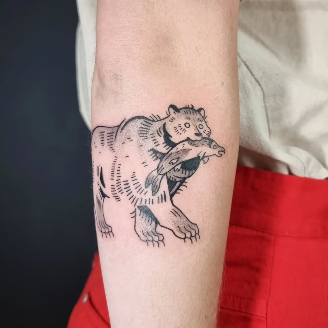 Stylish bear tattoo with a catch of fish