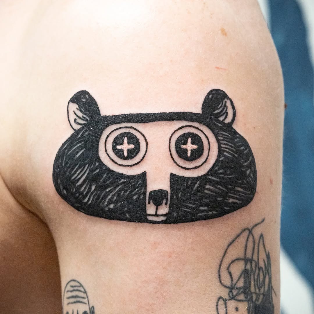 Quirky bear tattoo with playful eyes