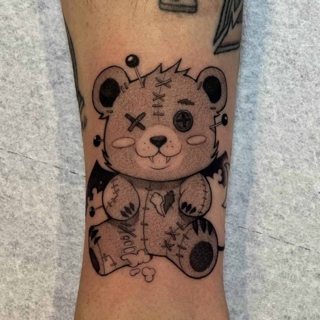 Adorable stitched bear tattoo with a quirky vibe