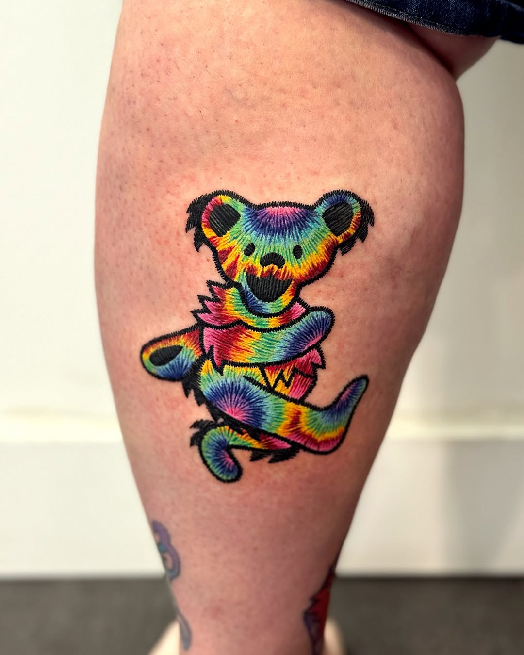 Vibrant bear tattoo with colorful designs