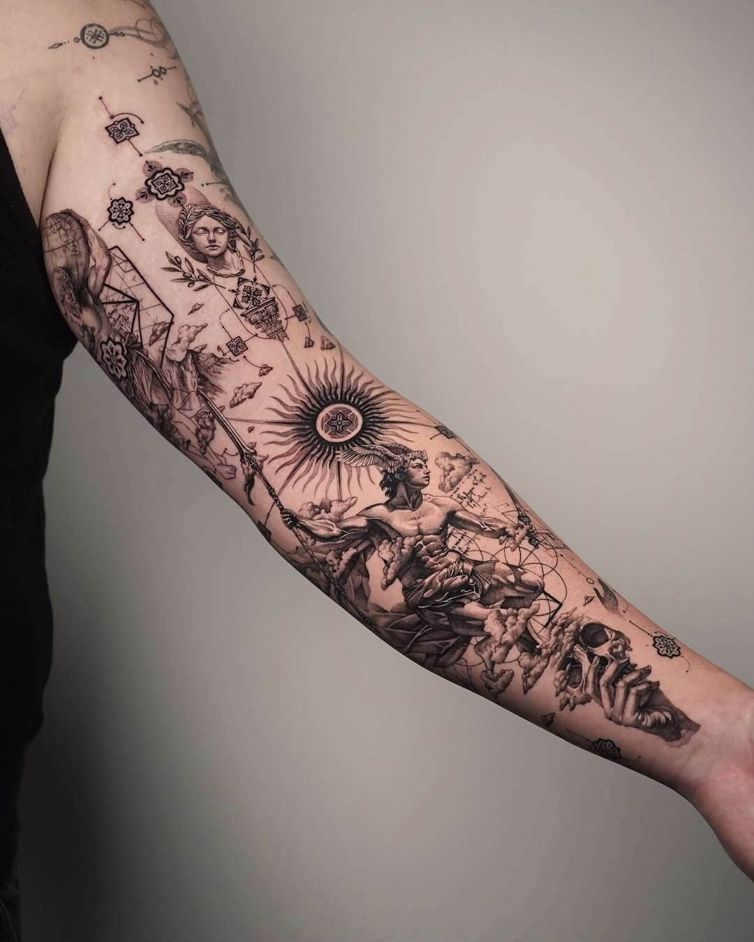 Intricate black ink forearm tattoo masterpiece