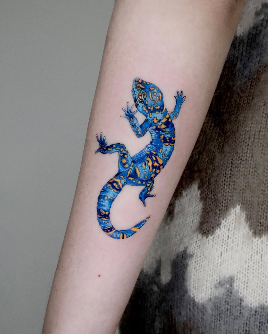 Vibrant gecko tattoo showcasing natural beauty