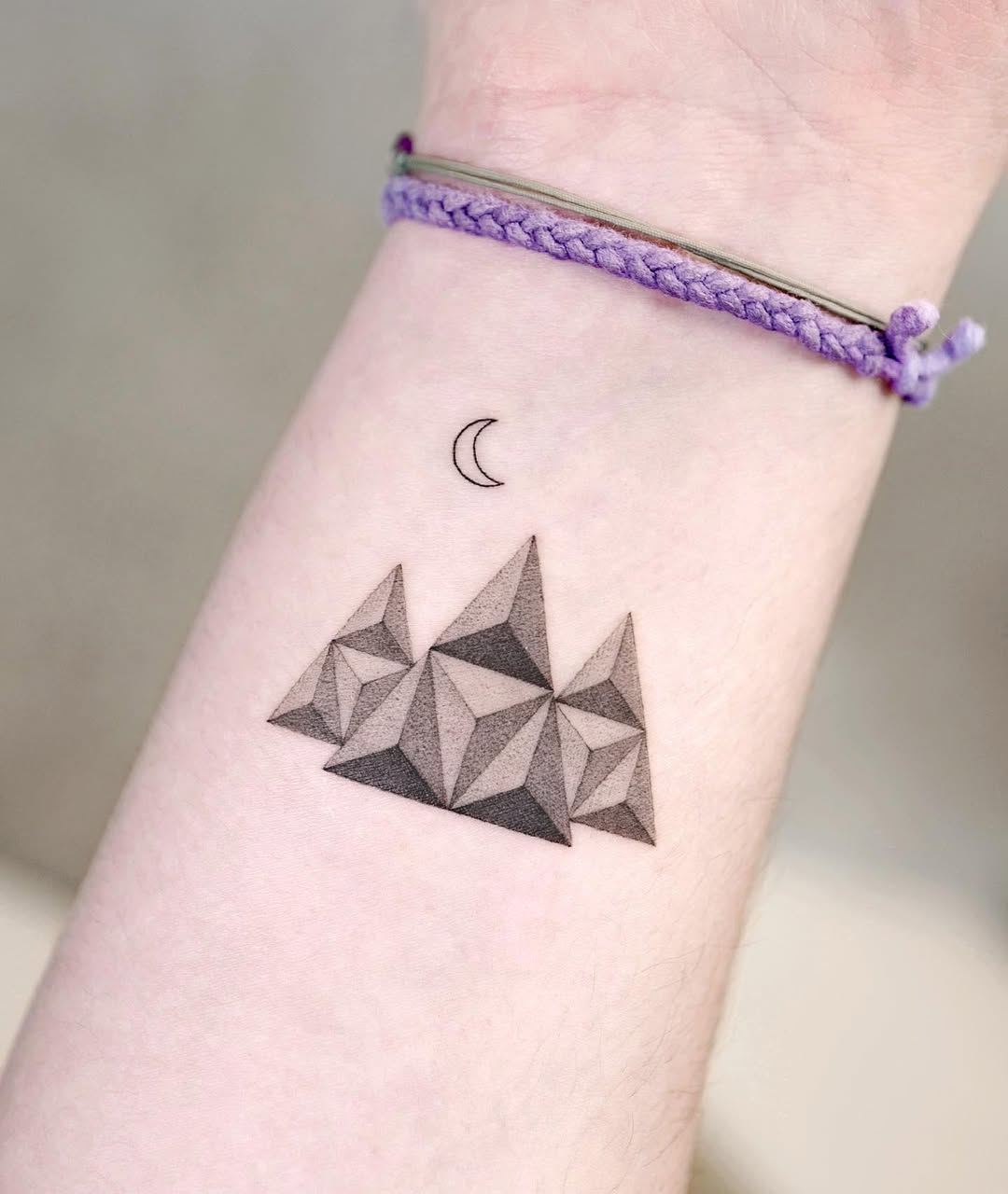 Stylish geometric mountain tattoo with crescent moon