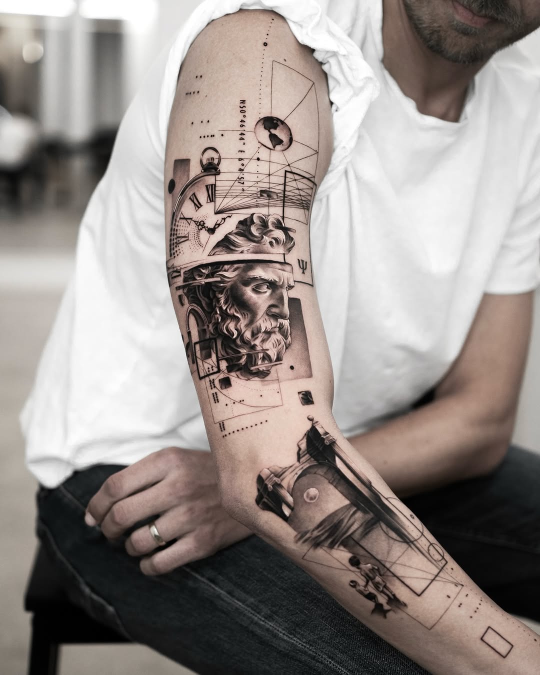 Intricate black and gray forearm tattoo design