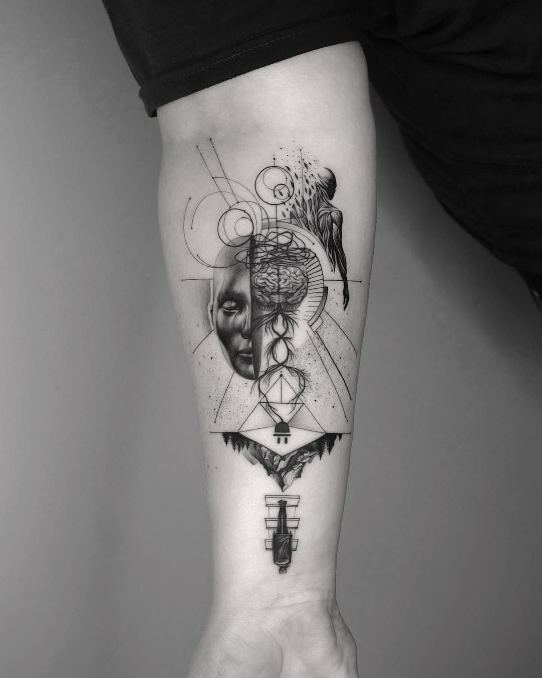 Striking black-and-white geometric forearm tattoo