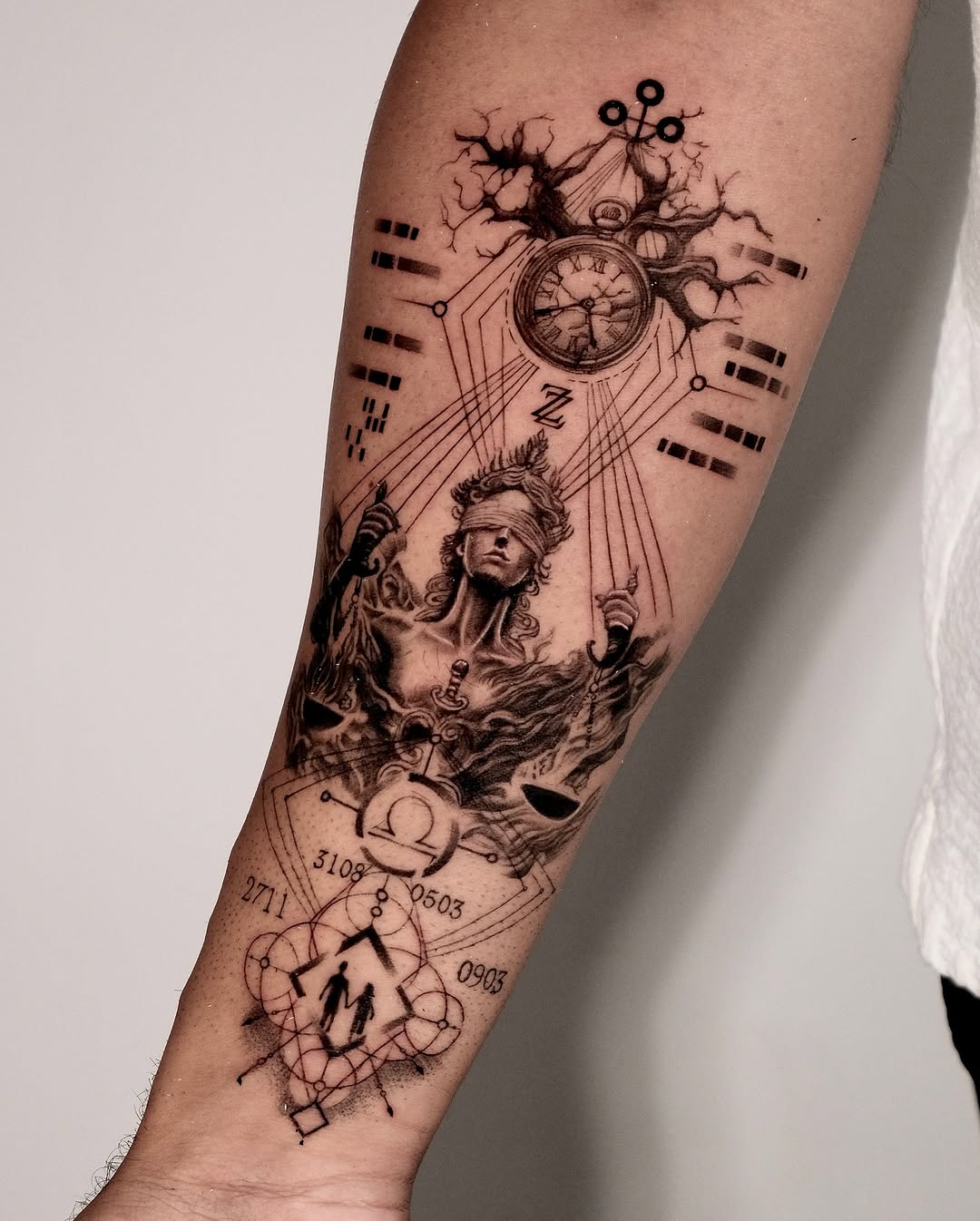 Intricate forearm tattoo blending time and space.