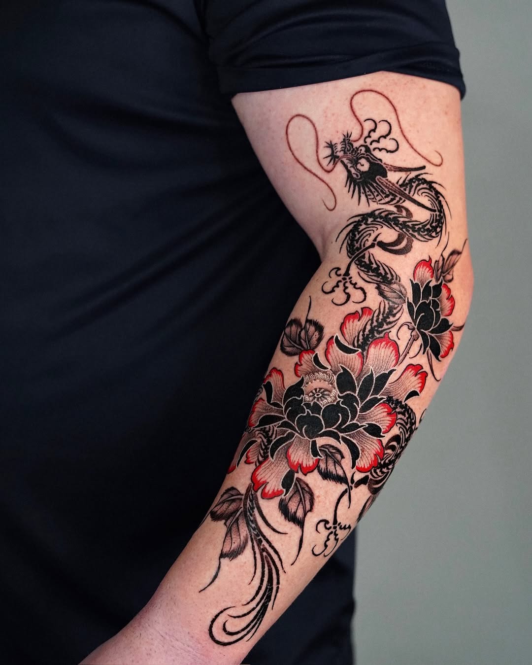 Stunning floral dragon tattoo on forearm