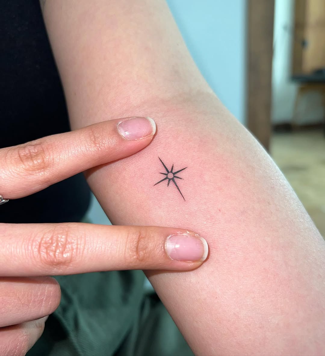 Sleek Star Forearm Tattoo in Black Ink