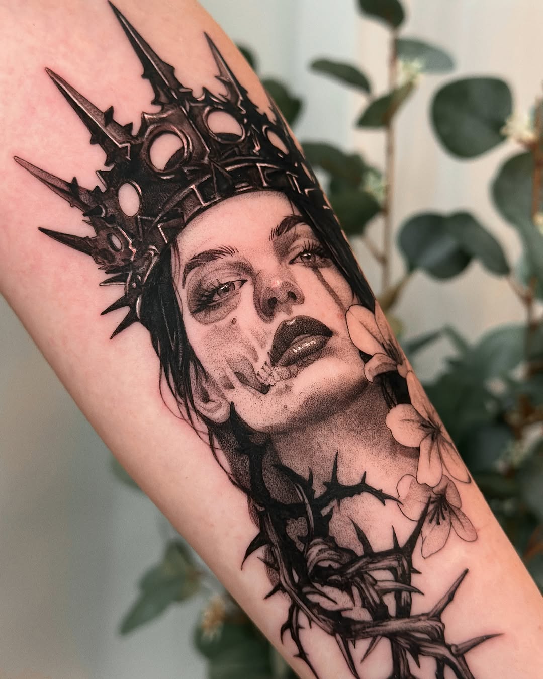 Dramatic skull and crown forearm tattoo design