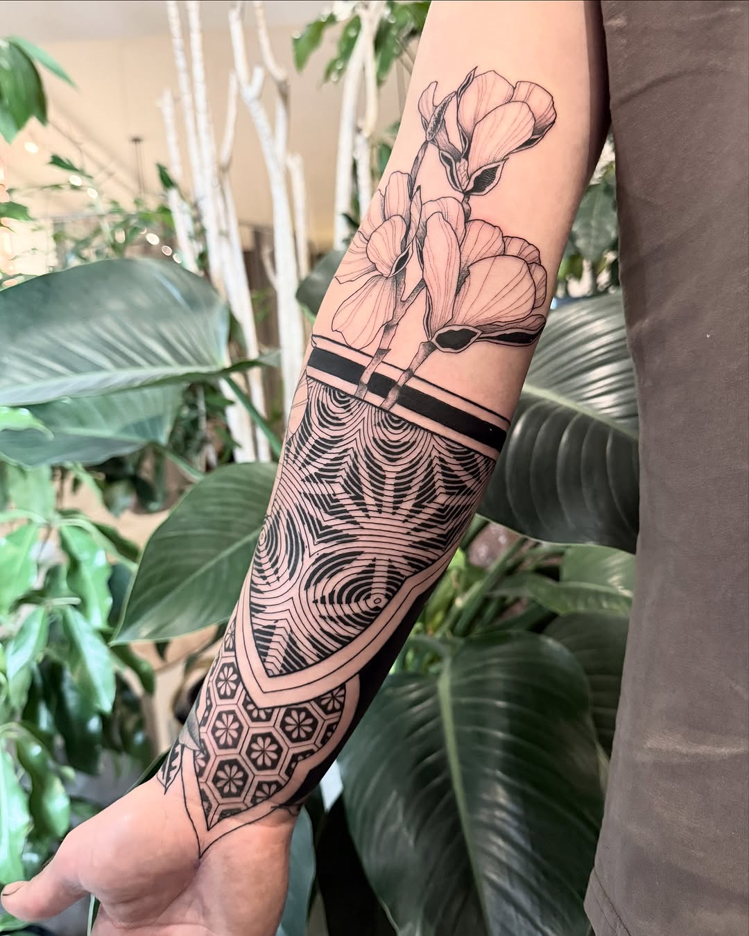 Stunning floral geometric forearm tattoo design