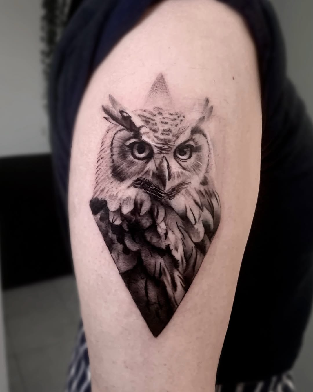 Stylish owl tattoo with a geometric touch