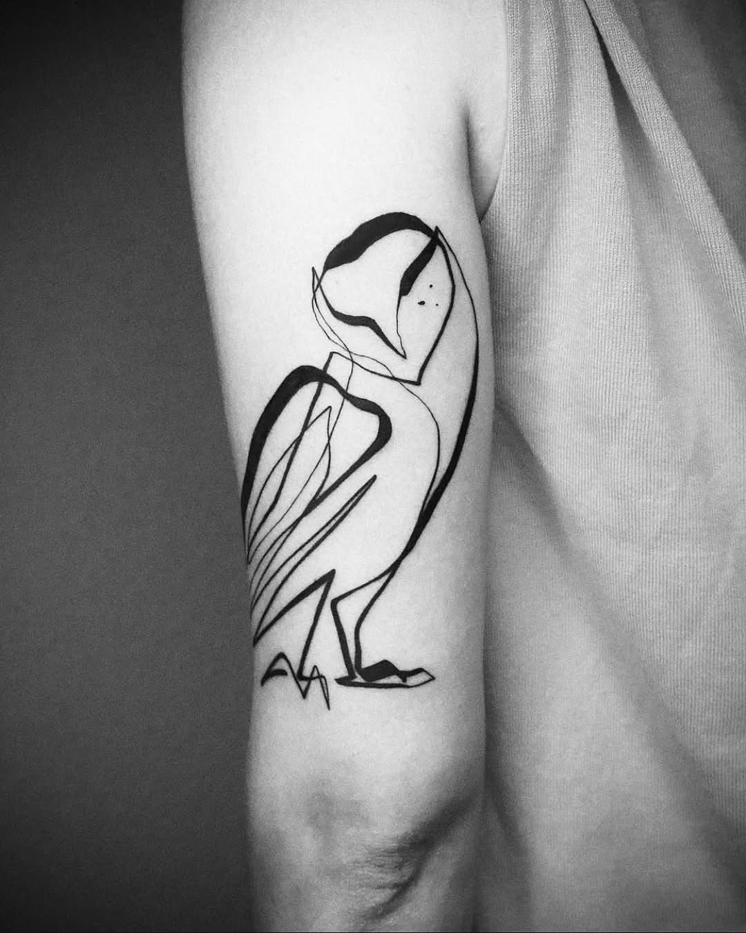 Minimalist owl tattoo in elegant line art