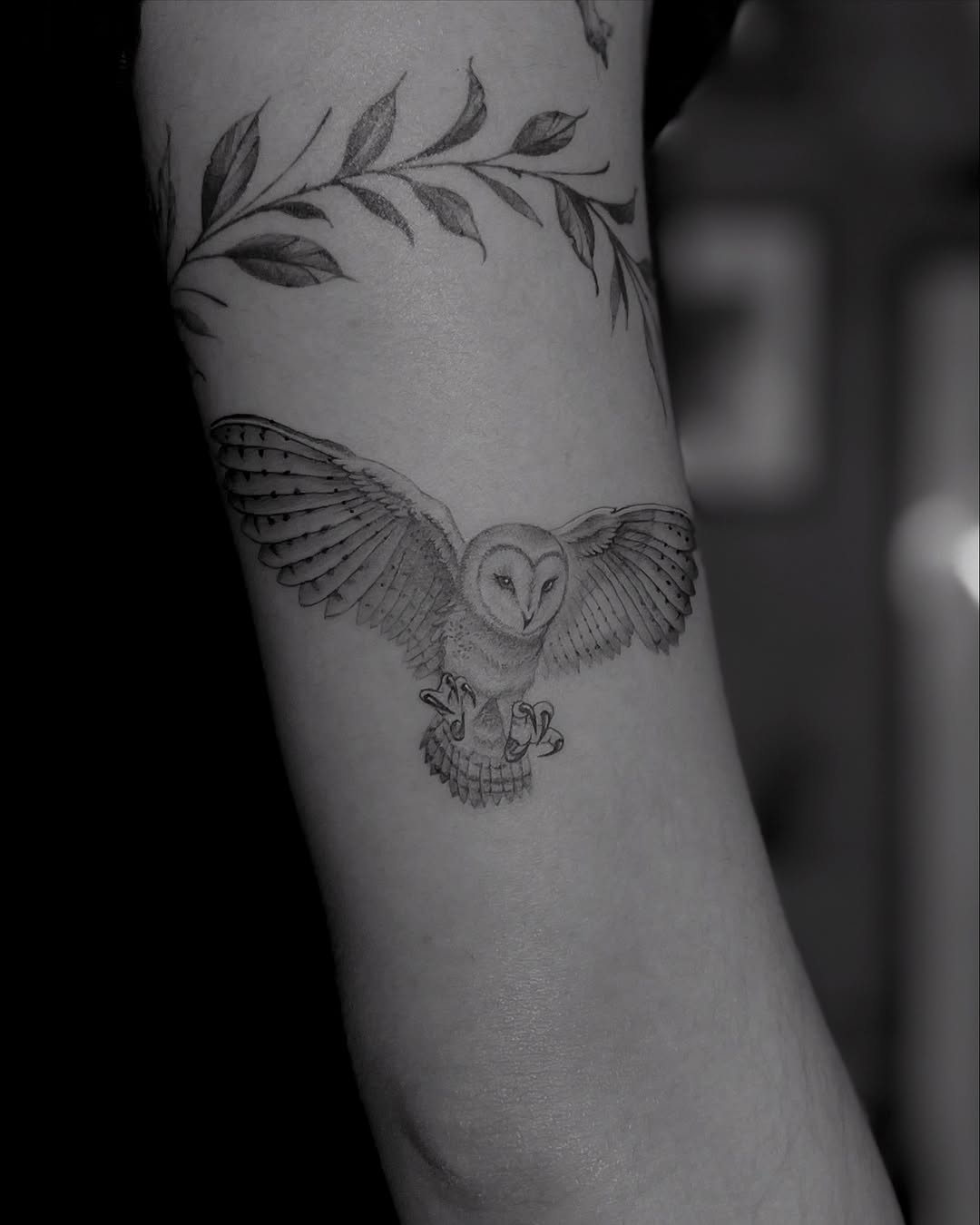 Elegant black and white owl tattoo in flight
