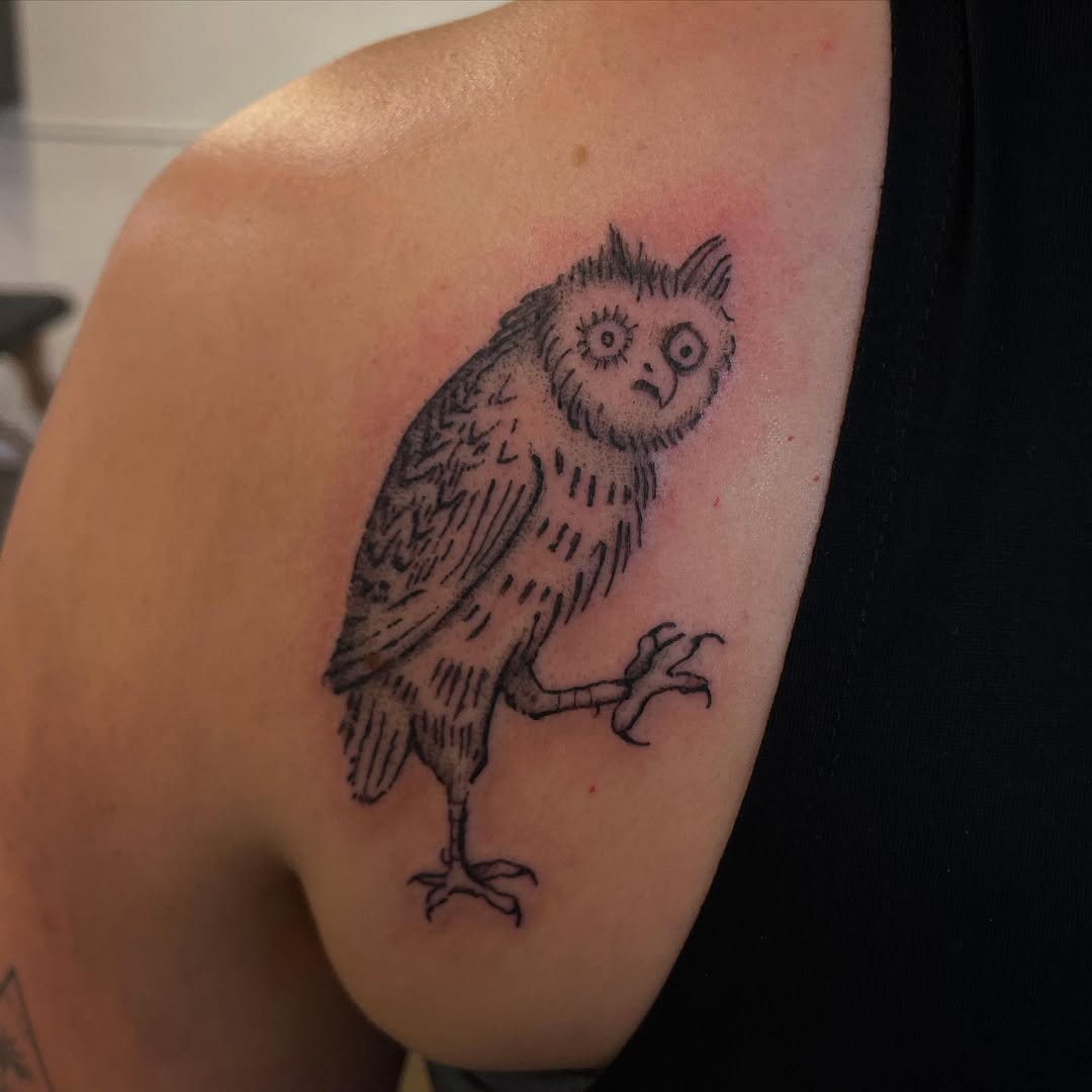 Charming owl tattoo with a quirky design