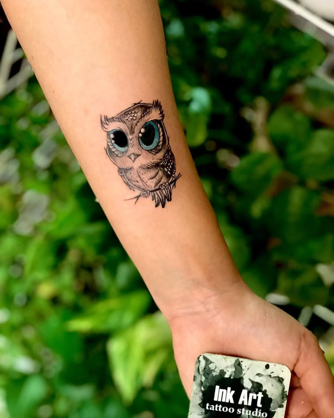 Whimsical owl tattoo with big expressive eyes
