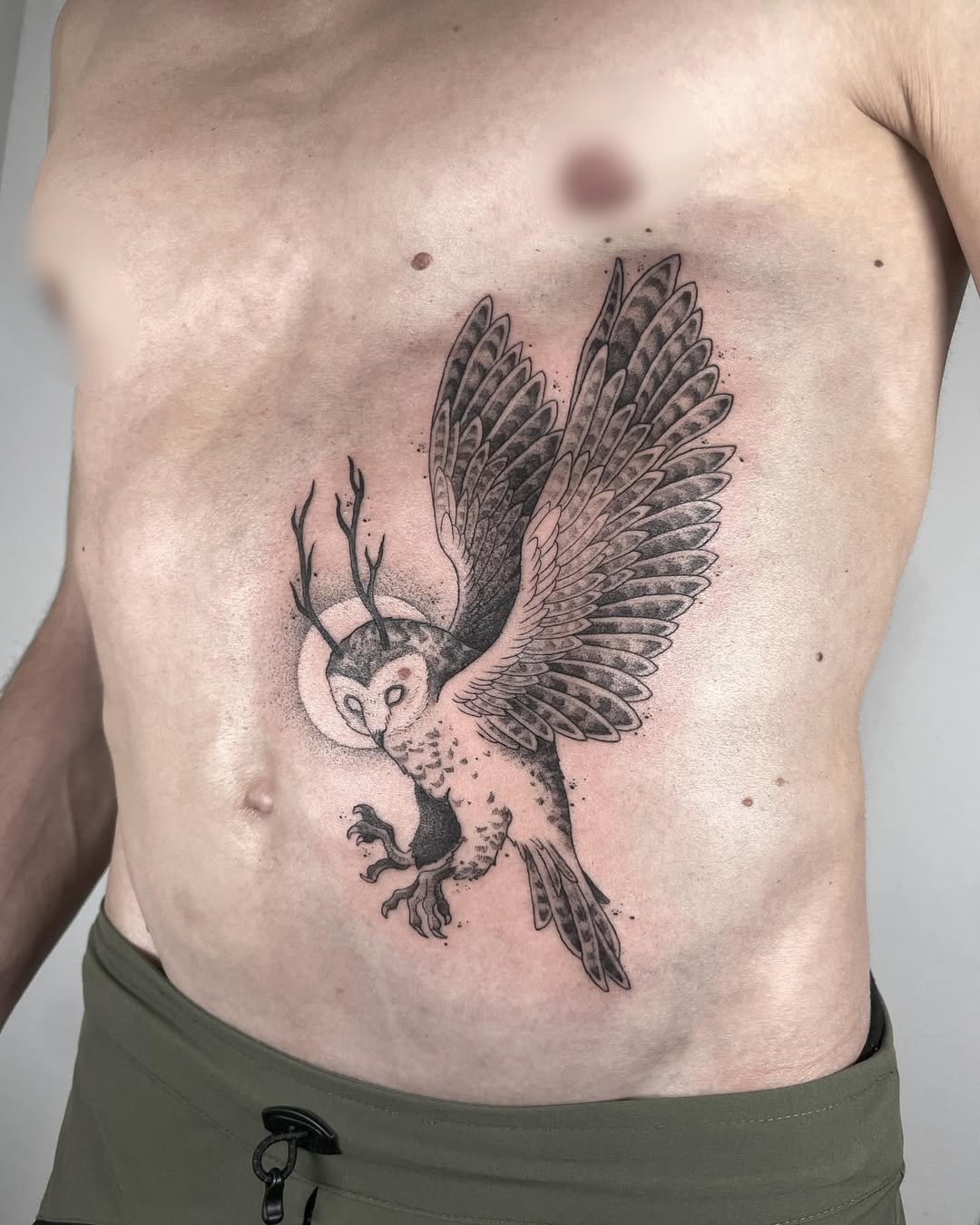 Majestic owl tattoo with striking wing design