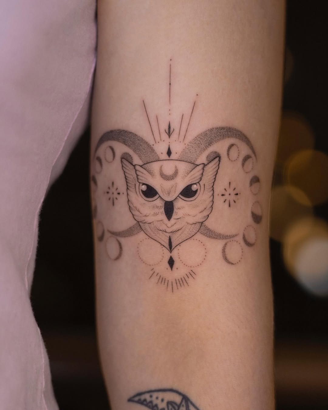 Mystical owl tattoo with moon phase aesthetic
