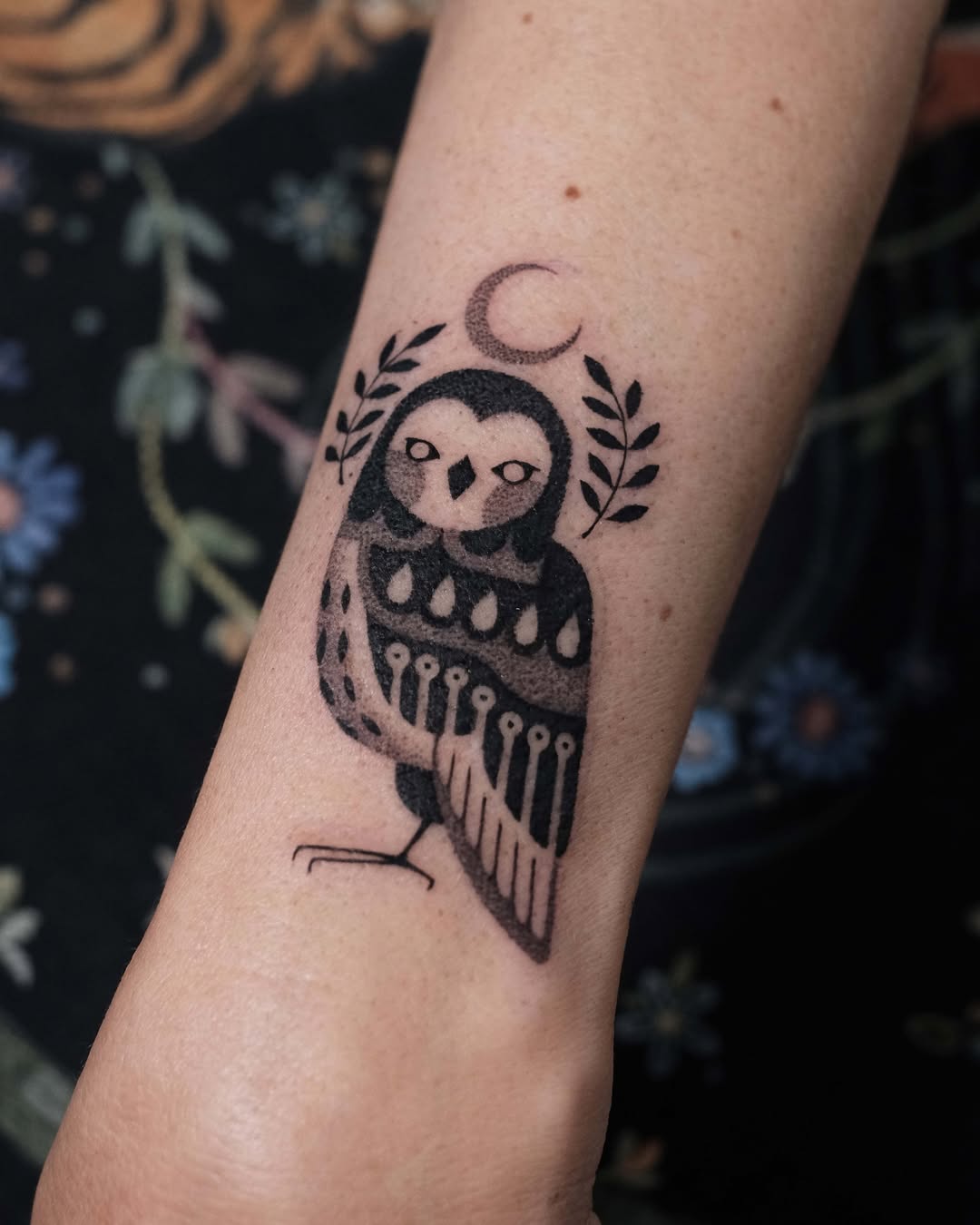 Artistic owl tattoo with crescent moon detail