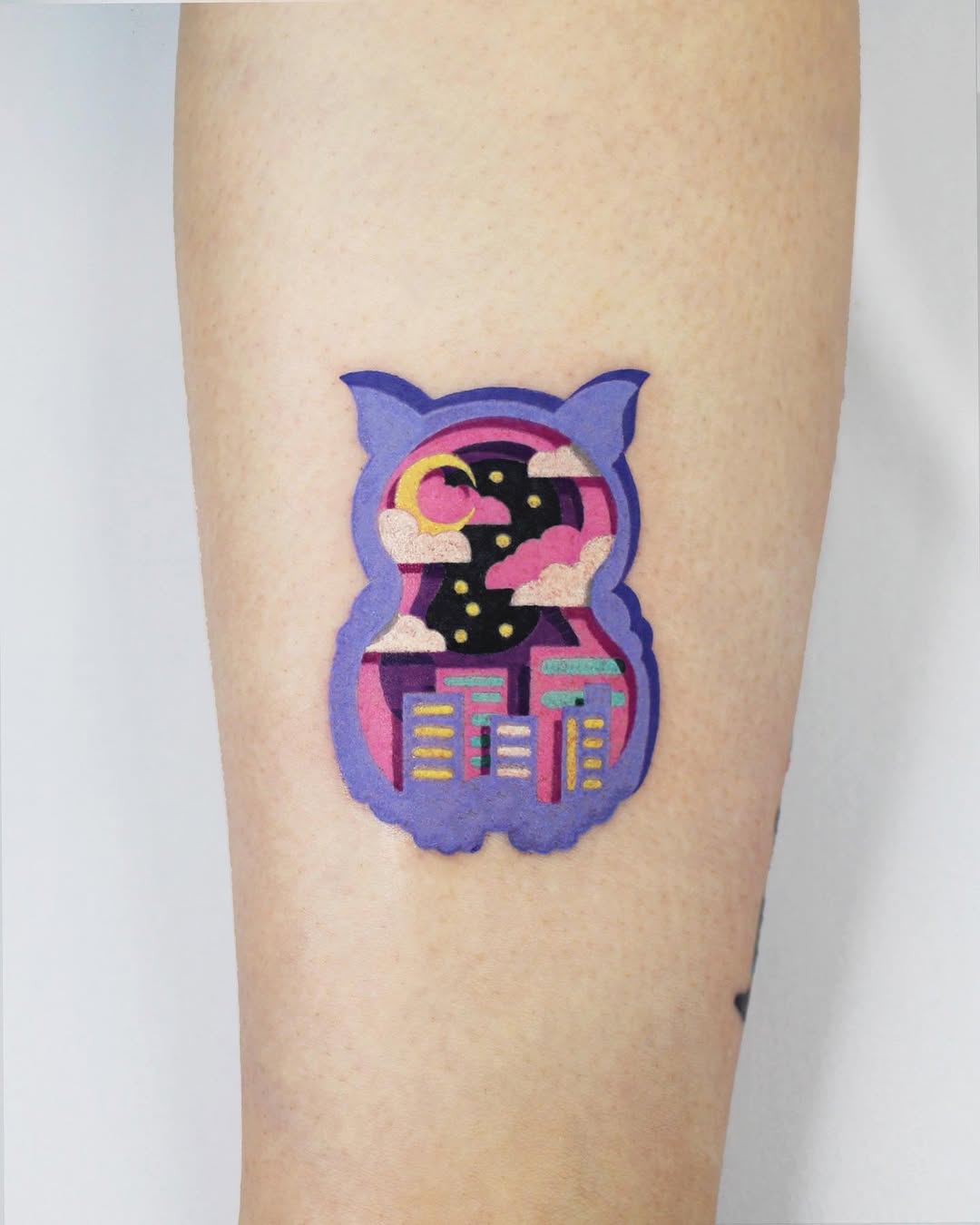 Unique owl tattoo with cityscape and night sky