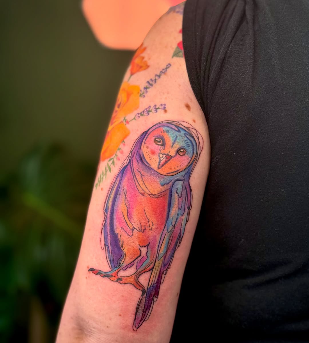 A vibrant and artistic owl tattoo design