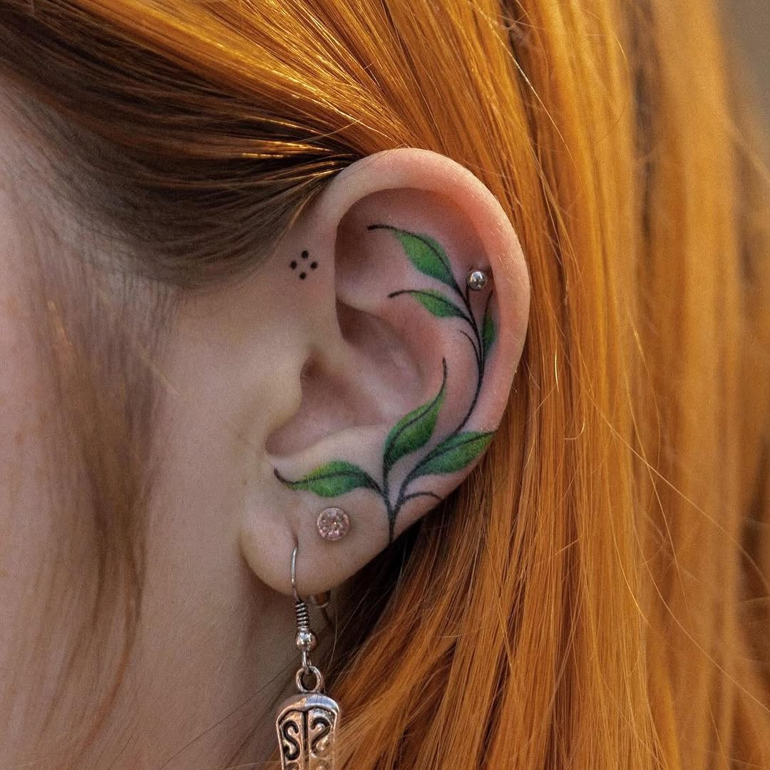Vibrant plant tattoo adorning the ear