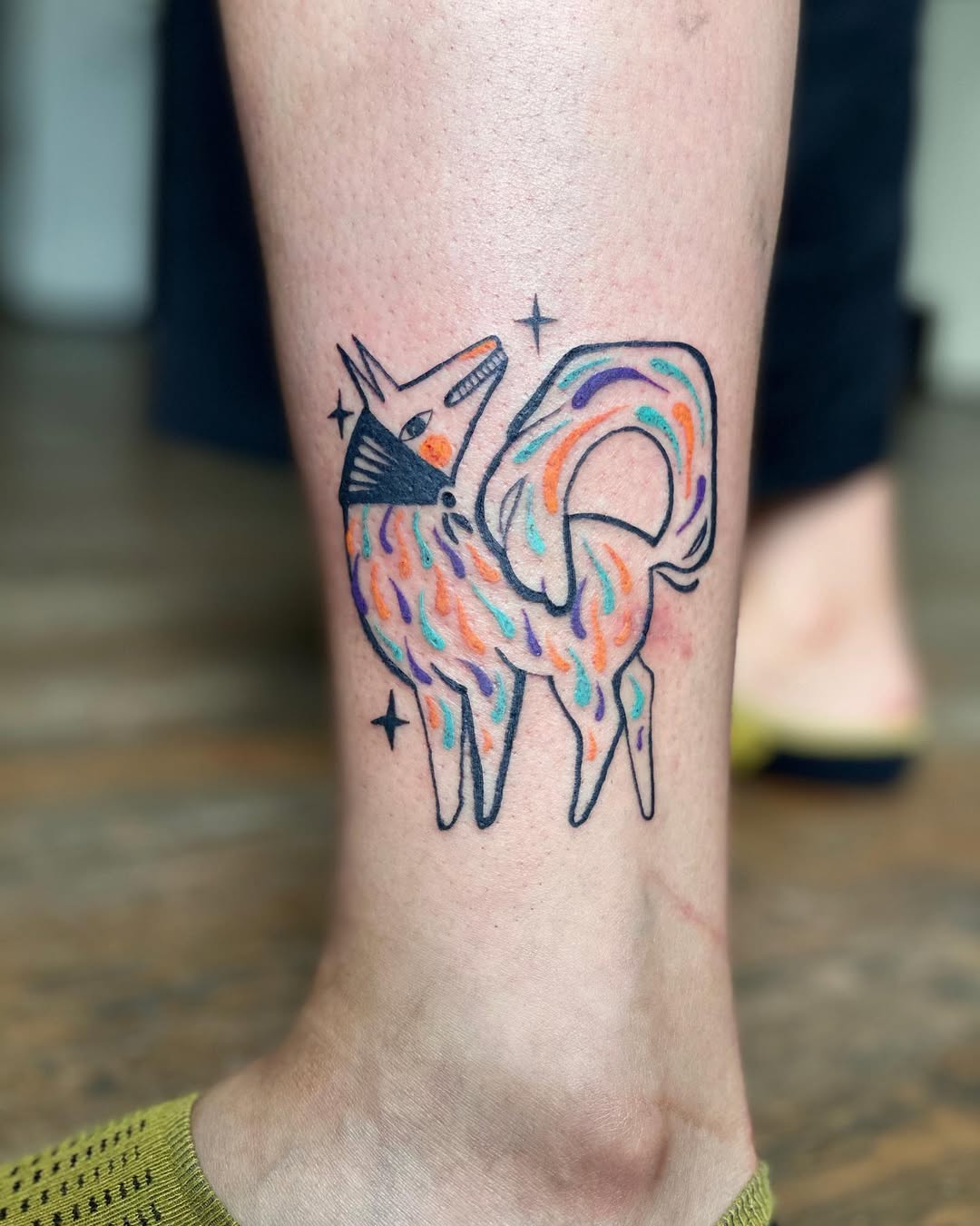 Vibrant fox tattoo with playful colors and style