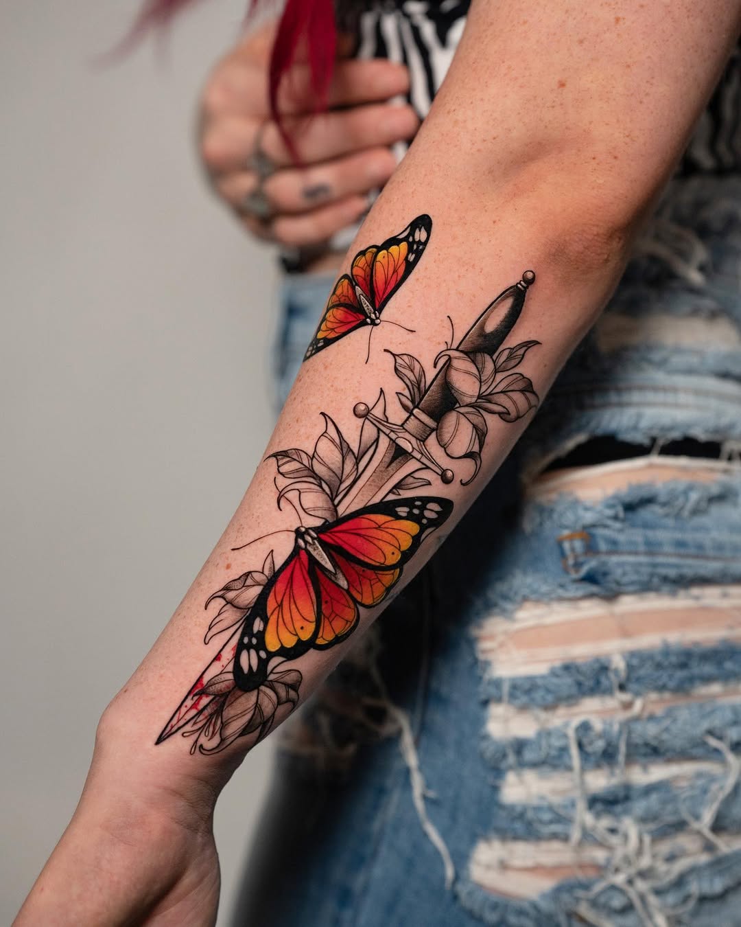 Stunning dagger tattoo with vibrant butterflies