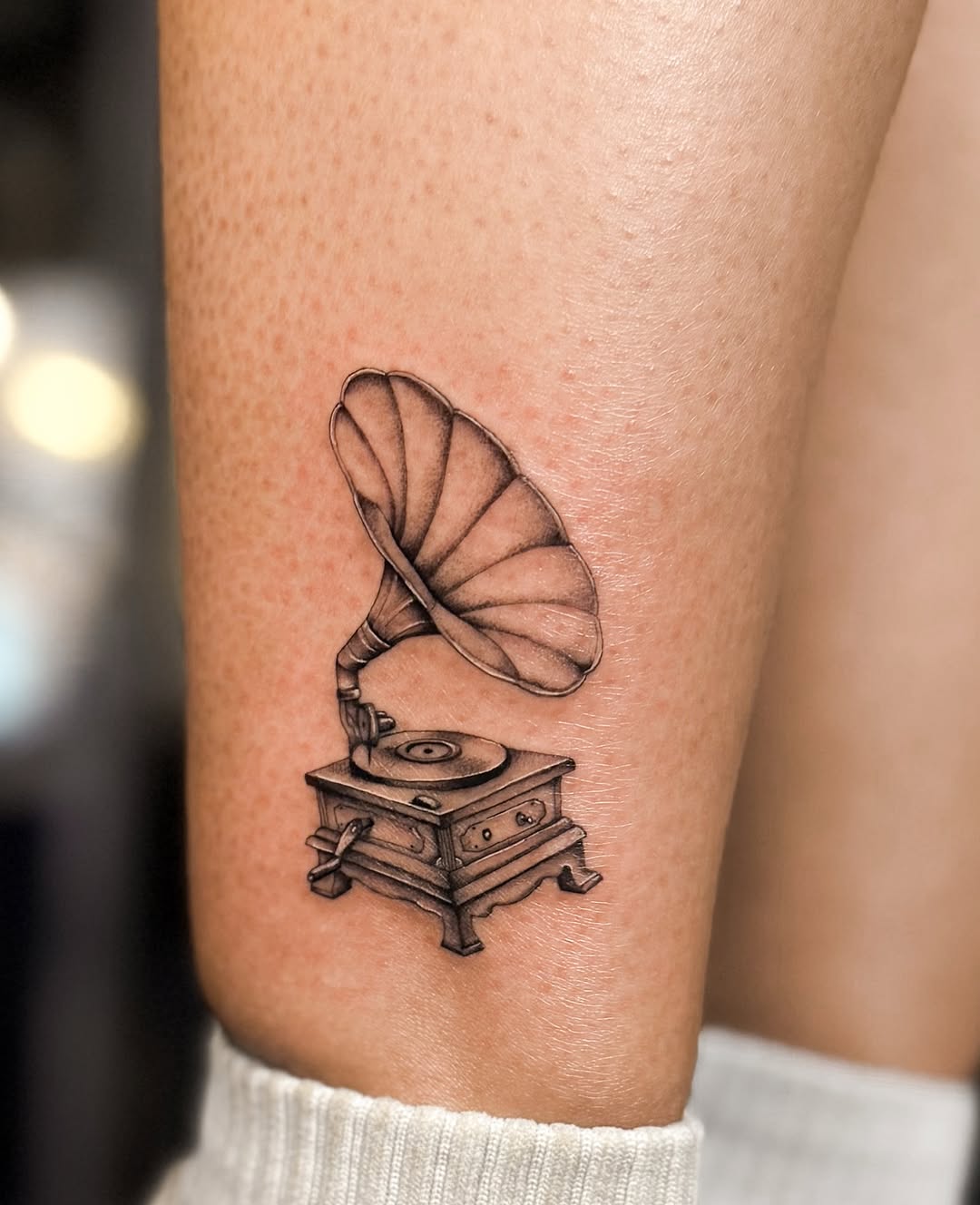 Elegant phonograph tattoo with a vintage vibe