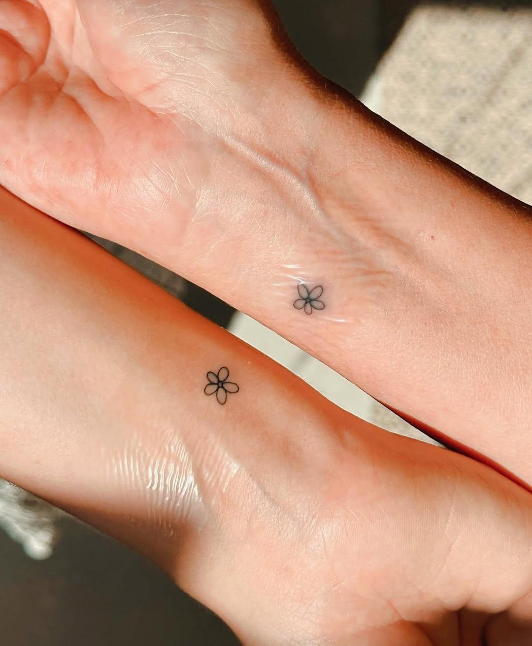 Charming minimalist flower tattoos on wrists
