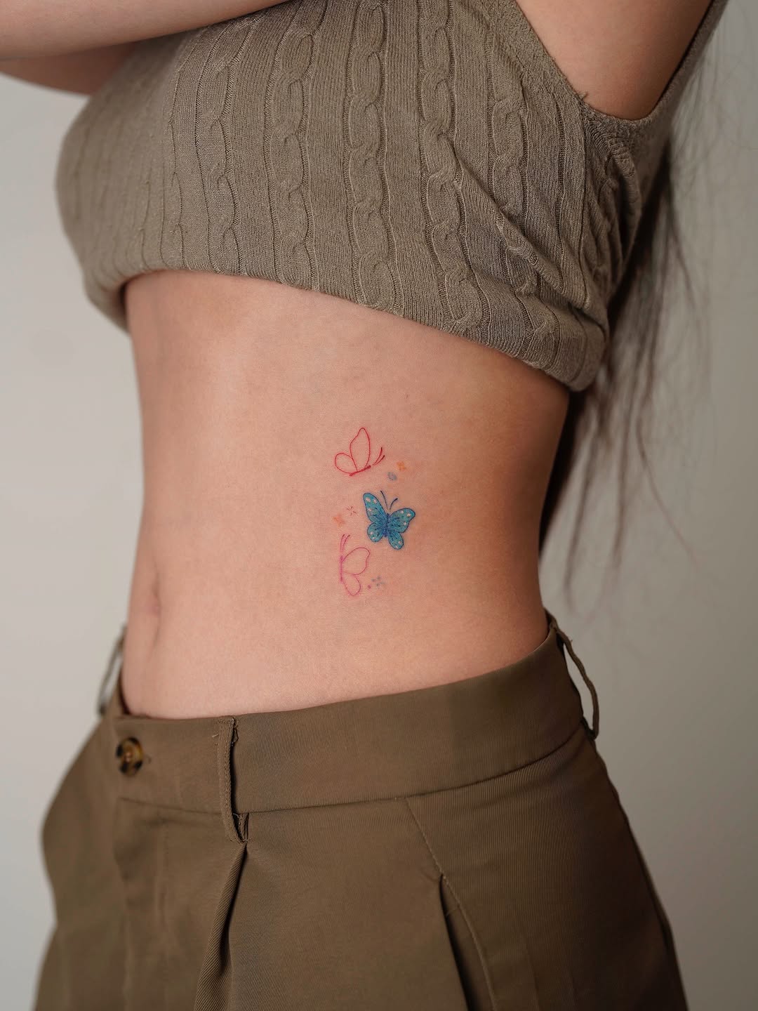 Delicate butterfly tattoo with floral accents