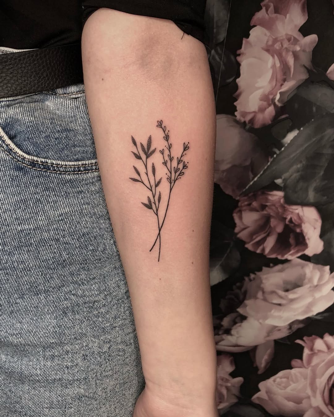 Elegant floral minimalist tattoo on forearm