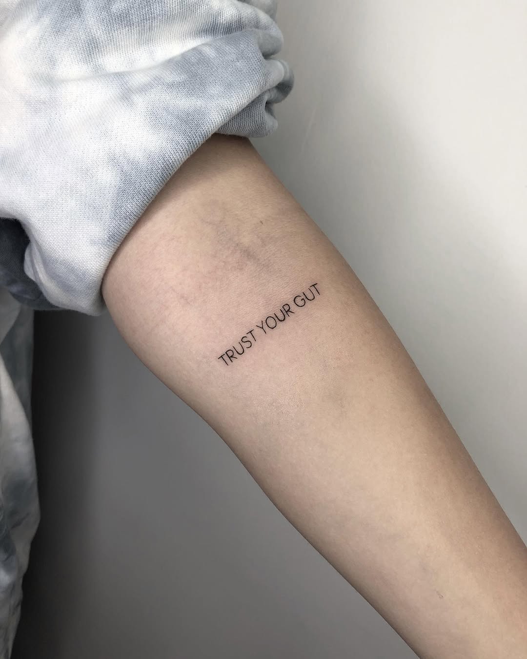 Simple text tattoo conveying strong intuition