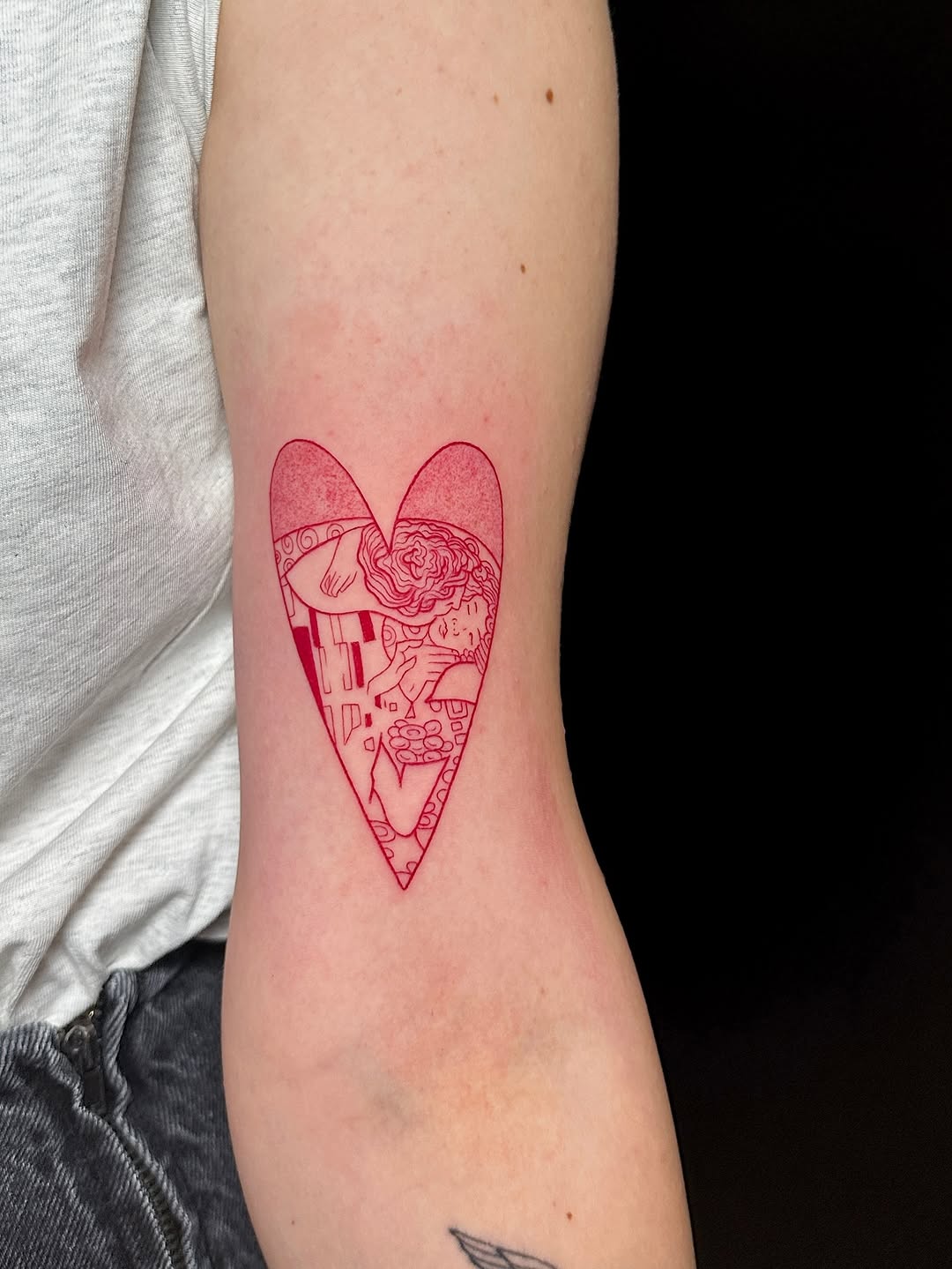 Intricate red heart-shaped minimalist tattoo design