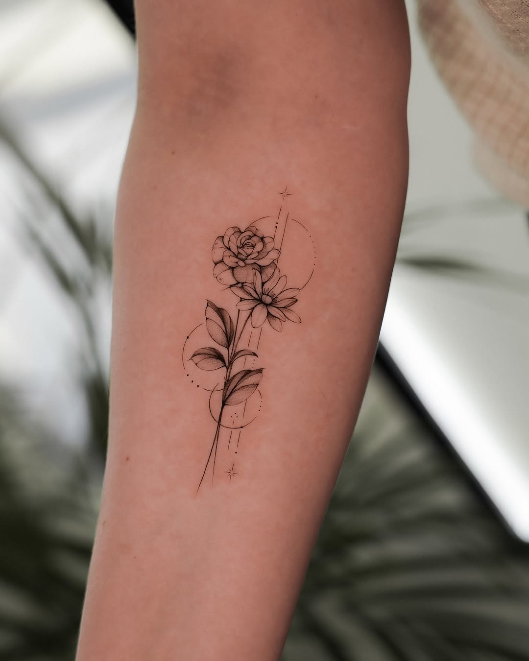 Elegant floral minimalist tattoo design on forearm