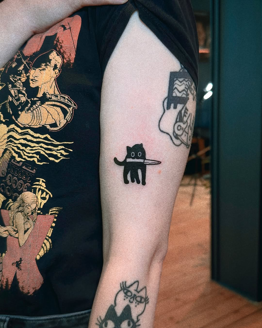 Charming minimalist cat tattoo with playful vibes