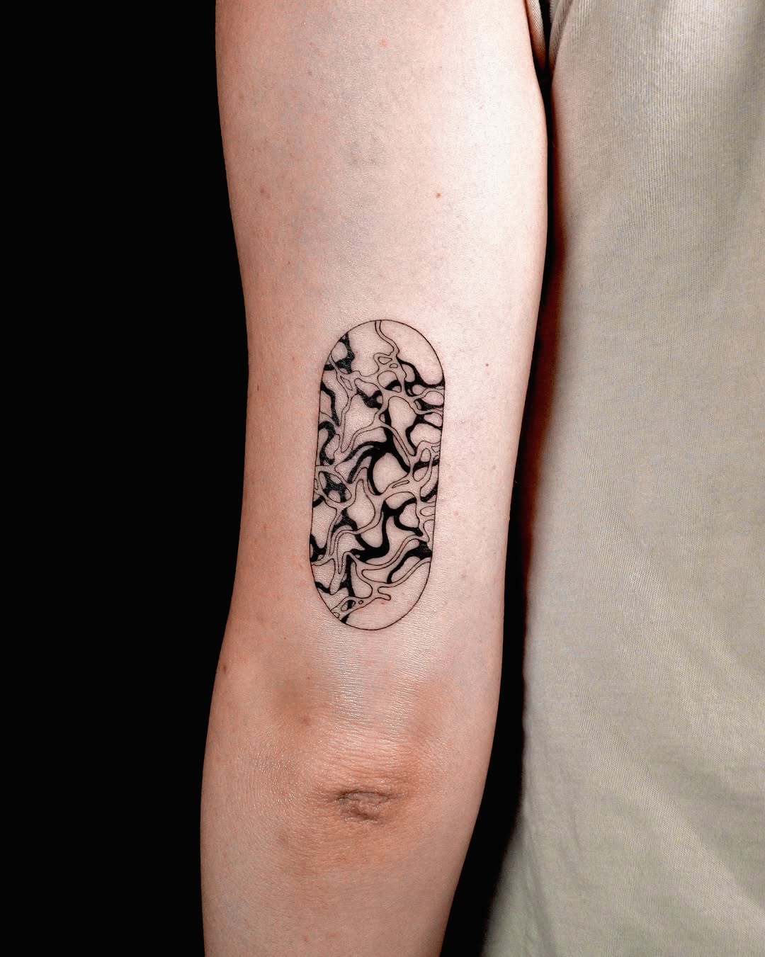 Sleek marbled effect tattoo on forearm