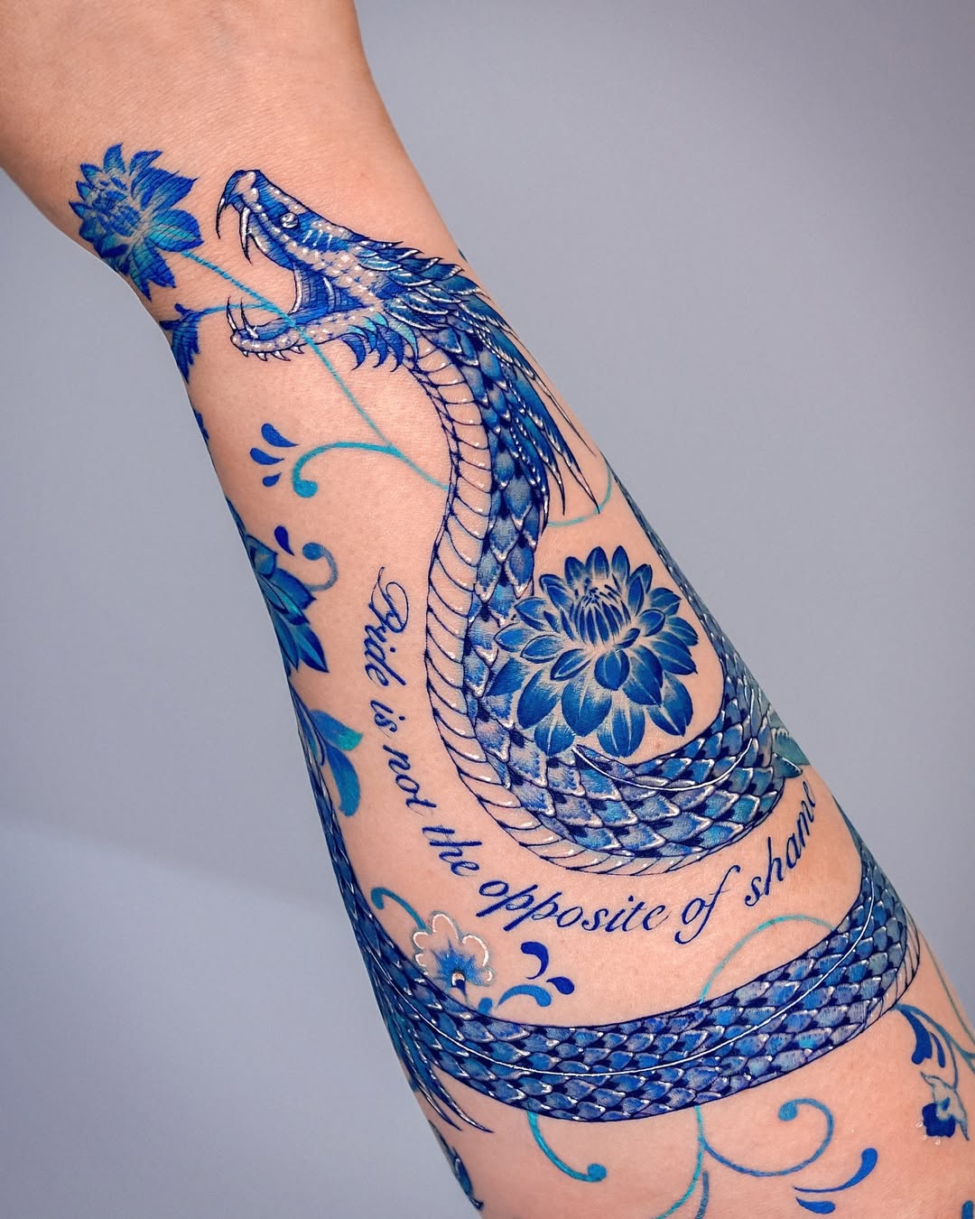 Stunning Blue Snake Tattoo with Floral Elements