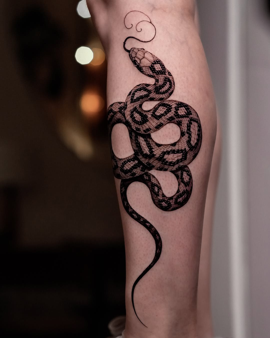 Intricate snake tattoo with ornamental flair