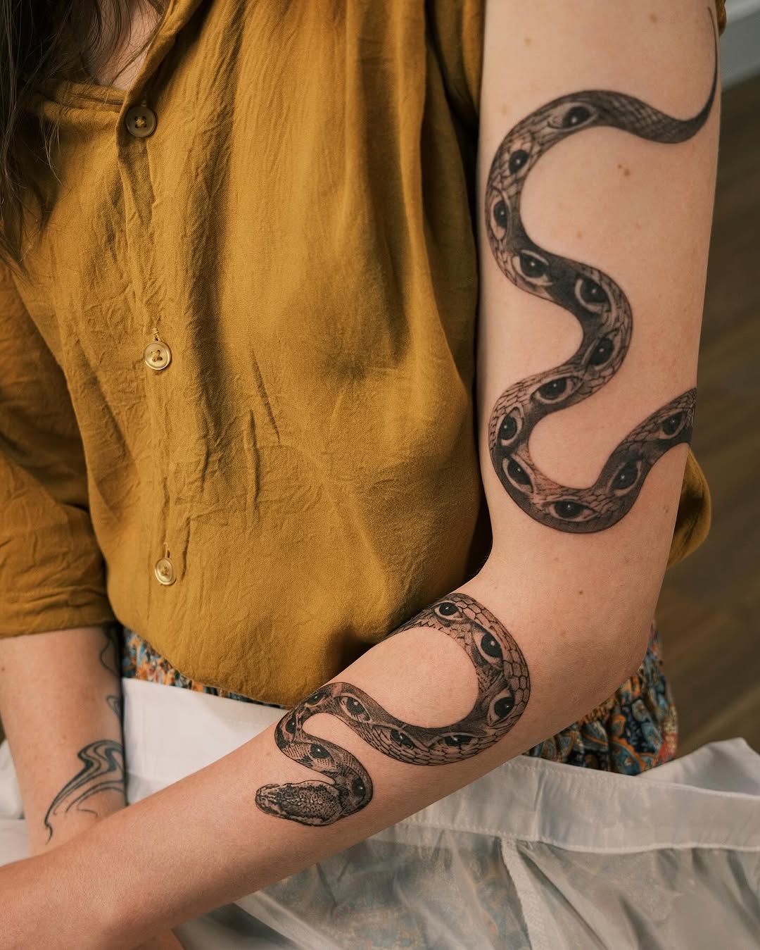 Intricate snake tattoo wrapping around the arm