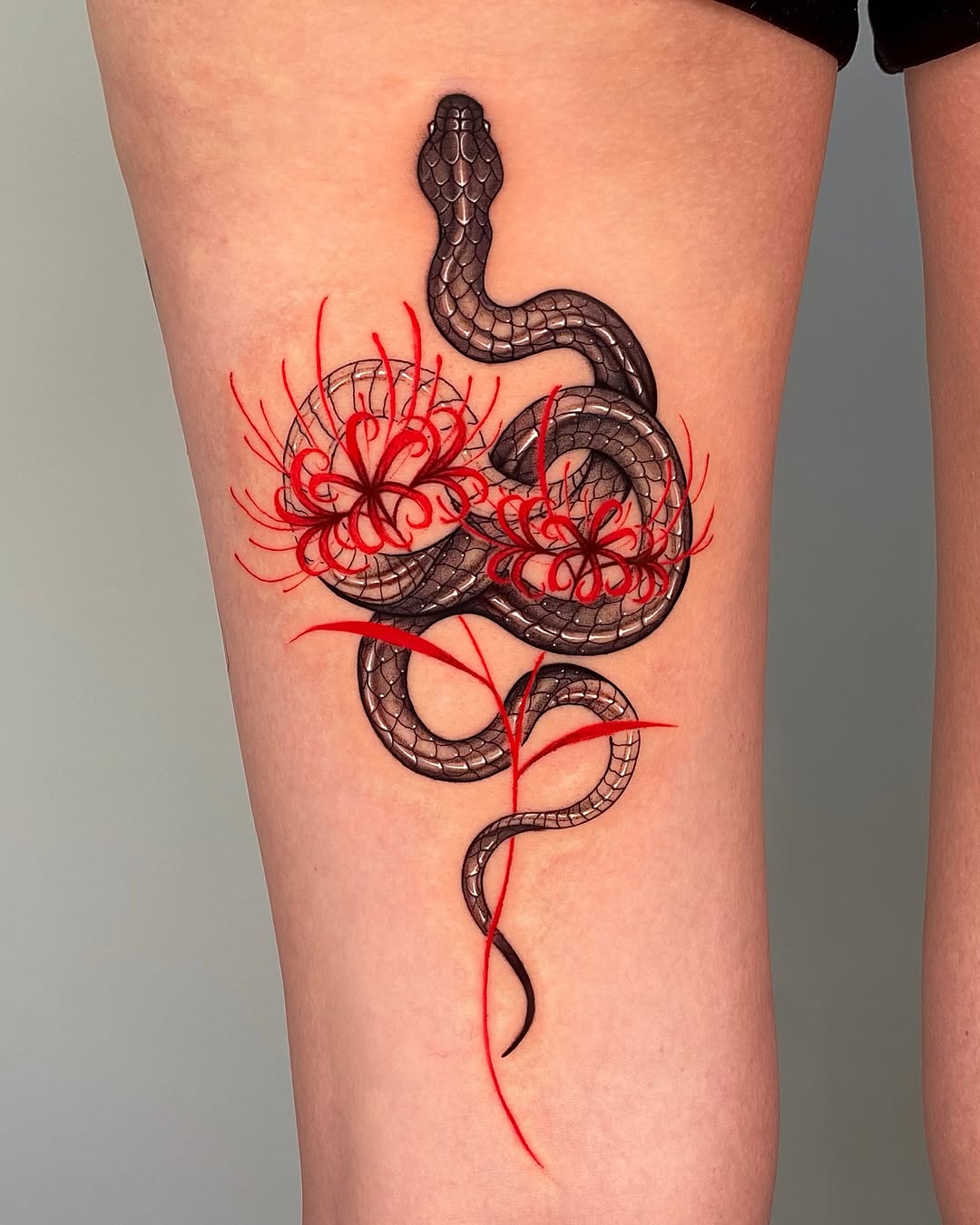 Elegant snake tattoo entwined with vibrant blooms