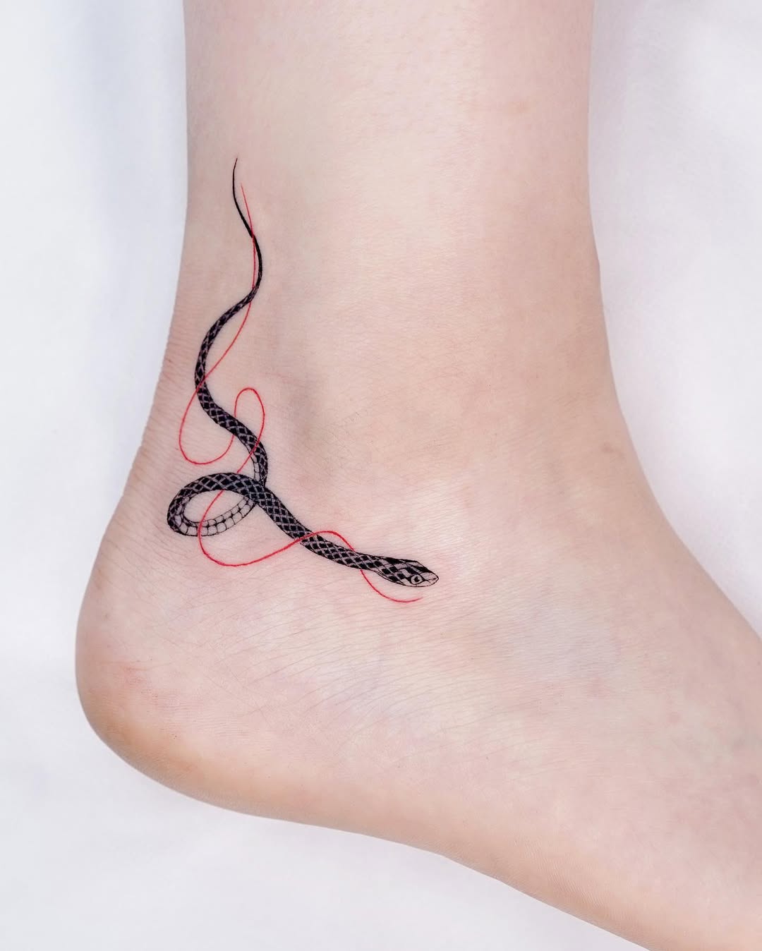 Elegant snake tattoo intertwining with bold lines