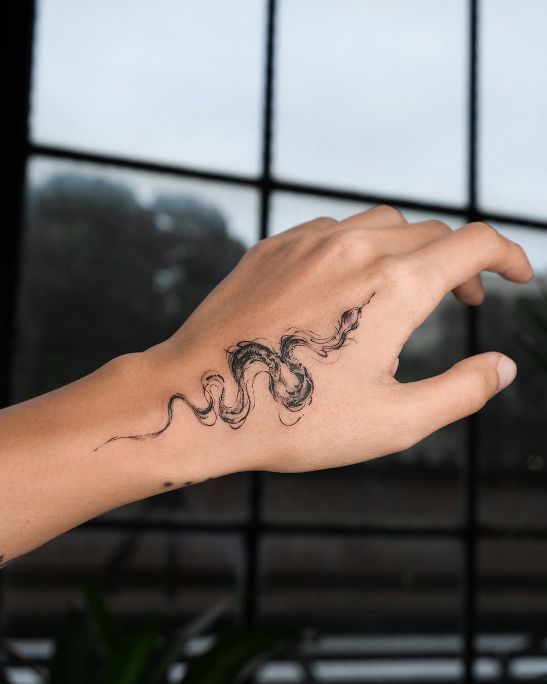 Intricate Snake Tattoo on Hand for Unique Style