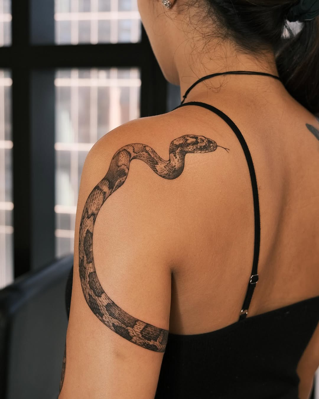 Realistic snake tattoo on upper arm