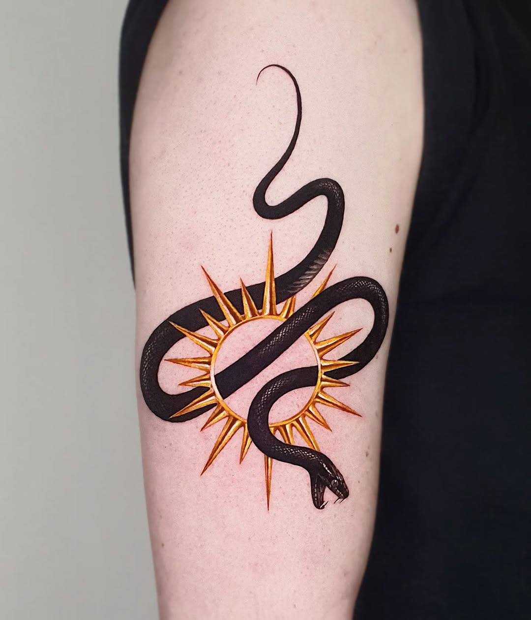 Elegant snake tattoo with sun motif