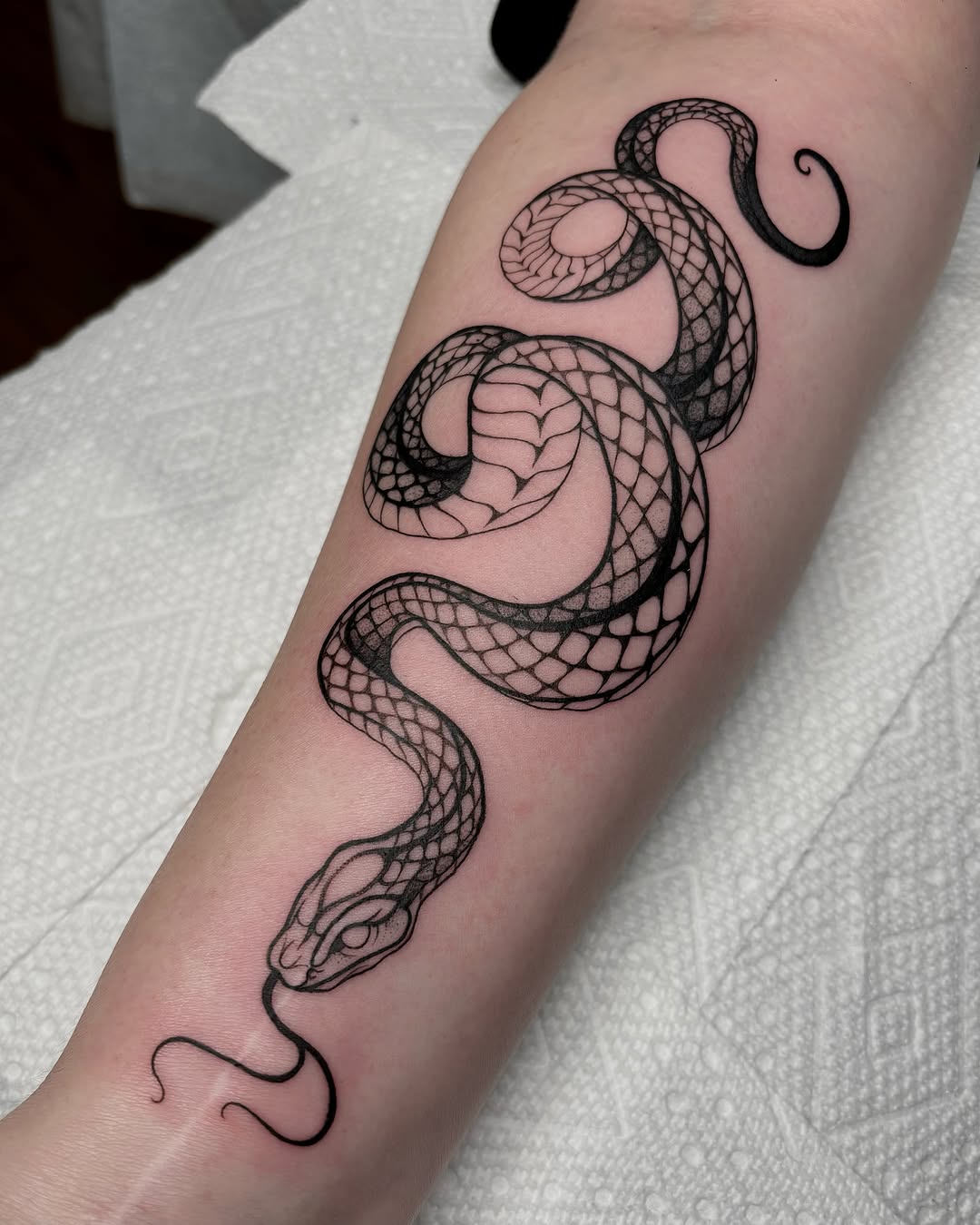 Intricate black ink snake tattoo design
