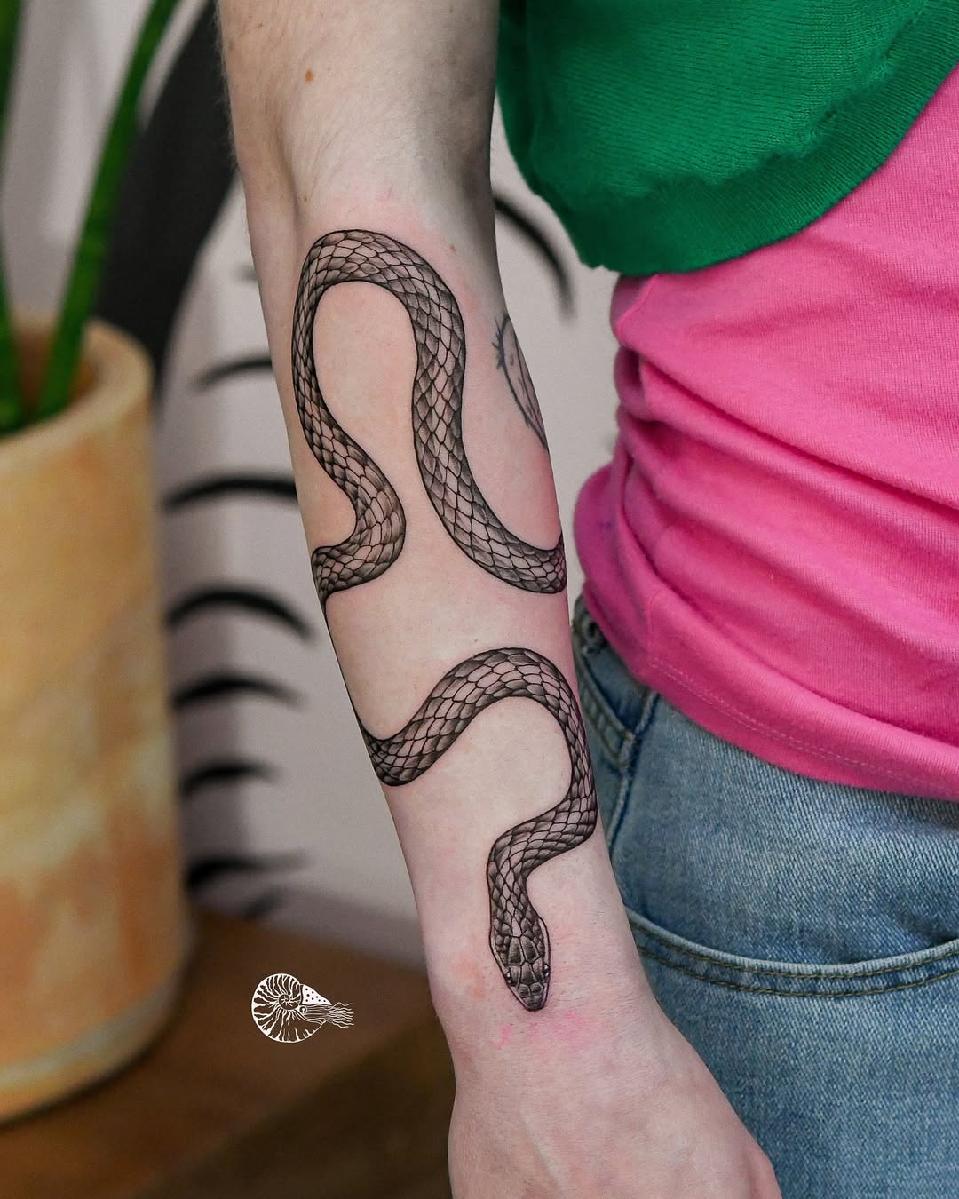 Elegant snake tattoo on a female arm