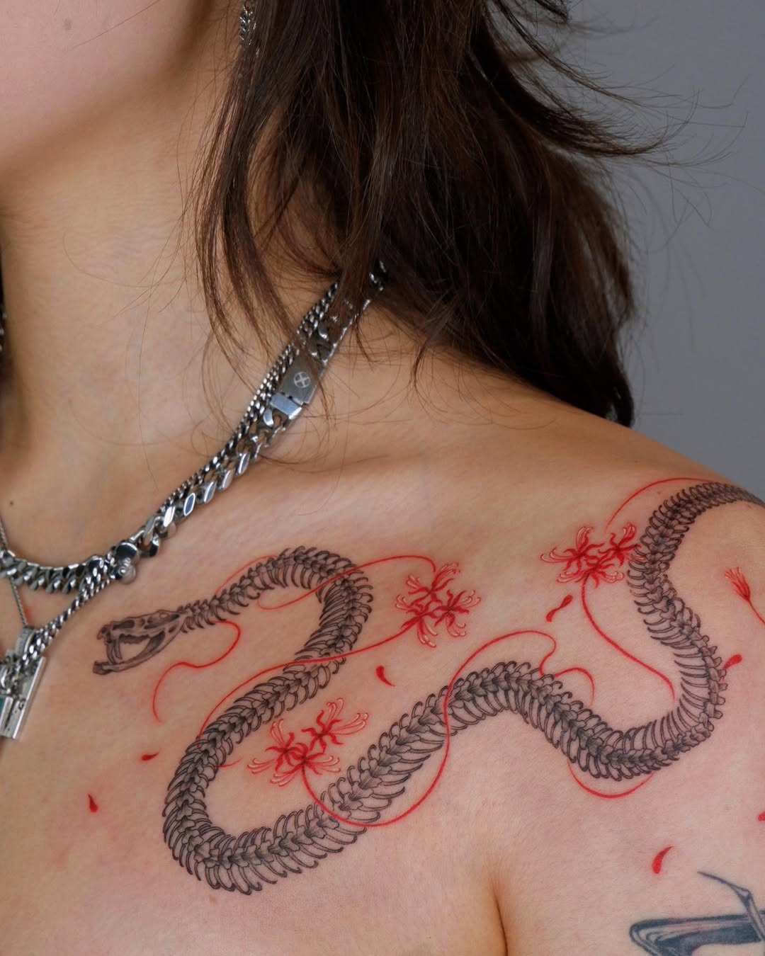 Elegant snake tattoo with floral accents